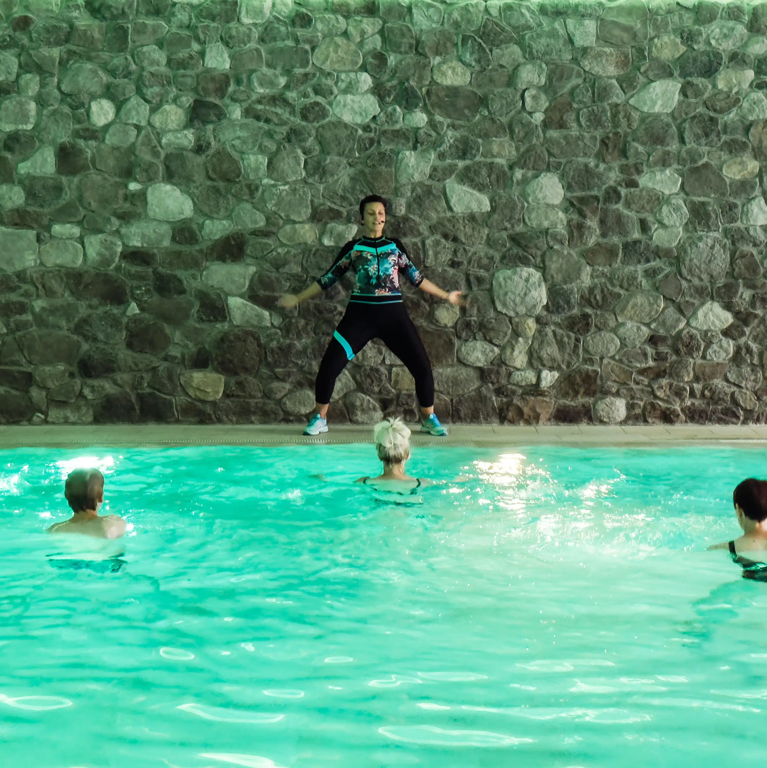A woman stands in a swimming pool.