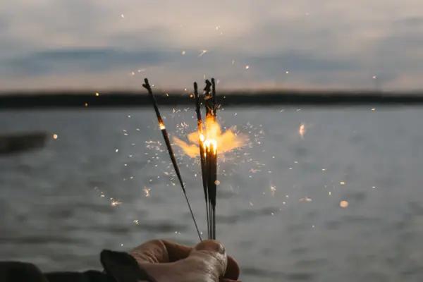 One hand holds a group of sparklers.