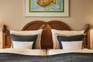 Bed with pillow and lamp on the bedside table