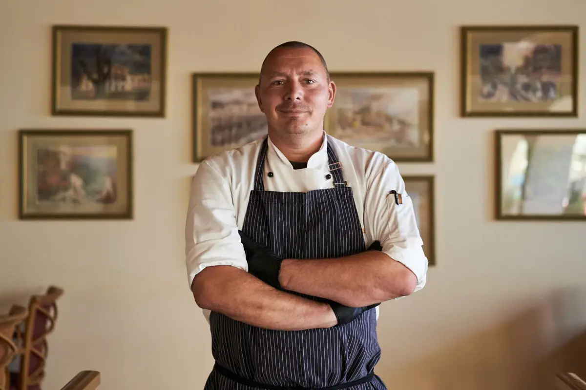 Cook A man wears a chef's apron.