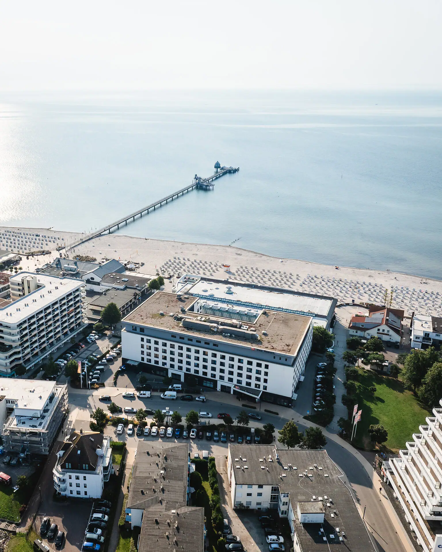 Aerial view of a beach with neighbouring buildings.