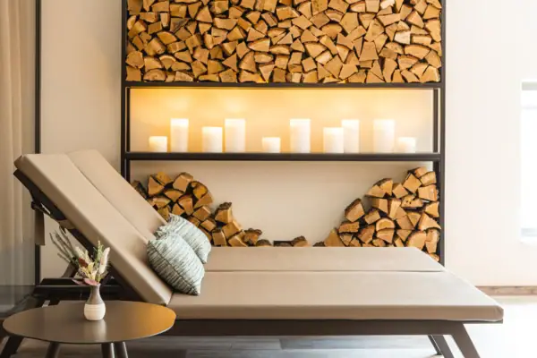 Relaxation area Lounge chair in a room with wooden shelves and candles