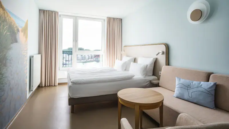 A room with a bed and a sofa.