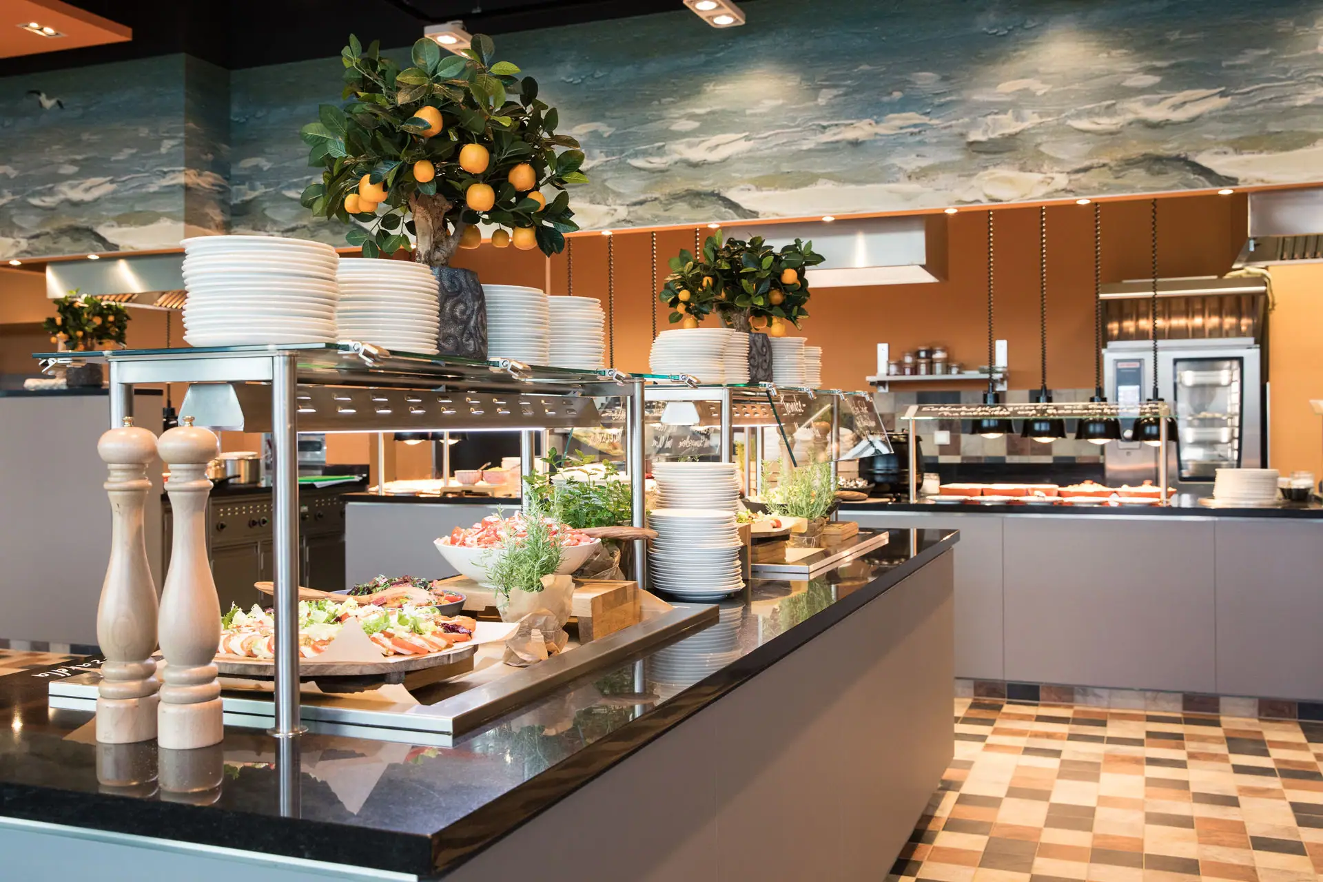 Buffet with plates and fruit on top