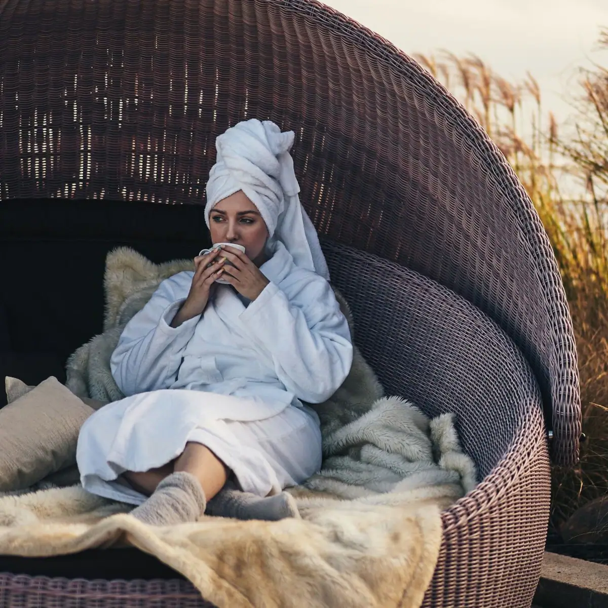 A woman sits in a chair.