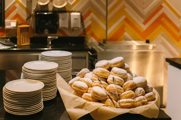 A pile of doughnuts on a counter.