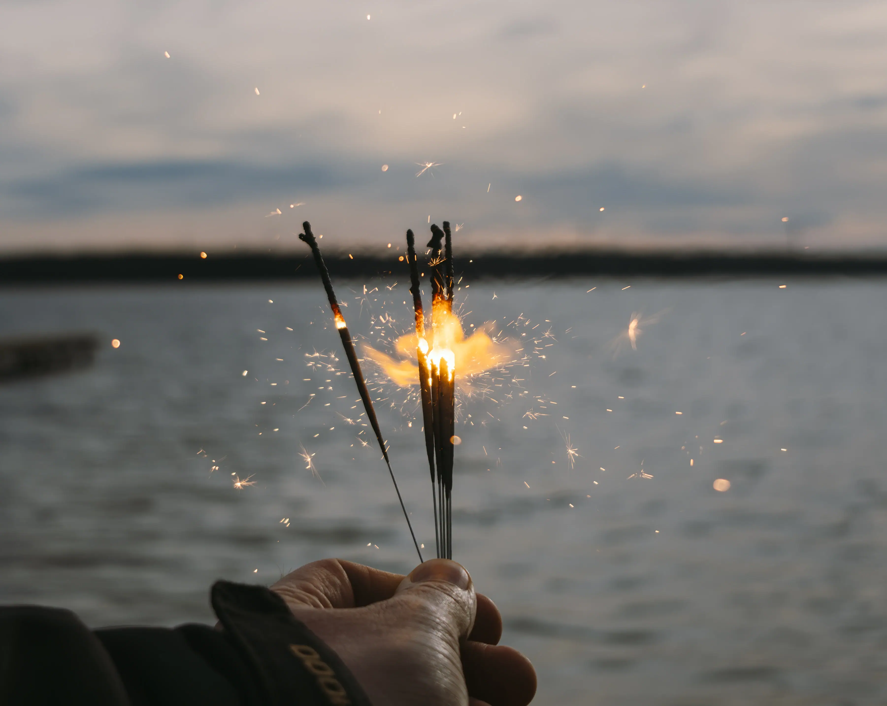 One hand holds a group of sparklers.