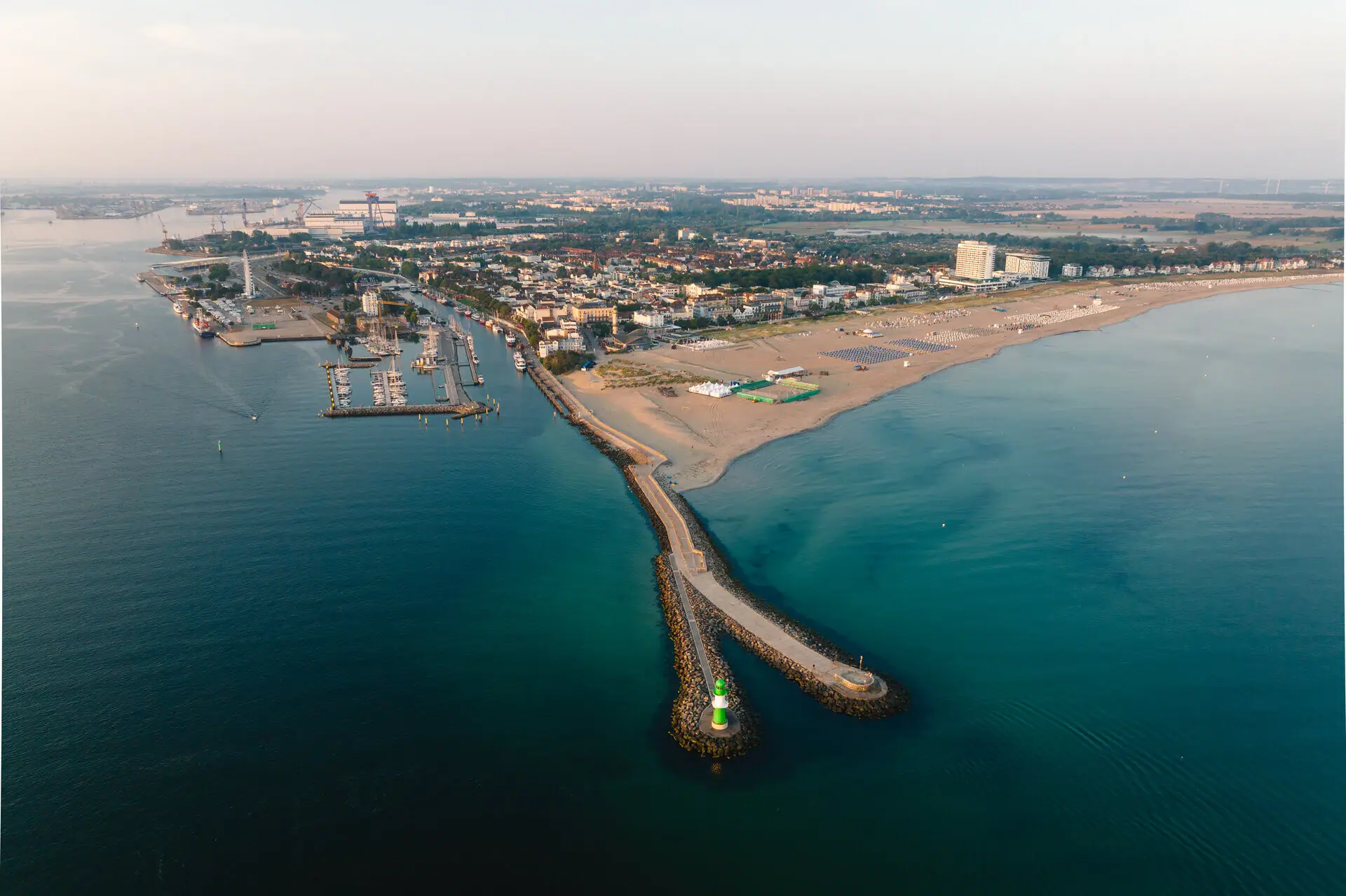 Aerial view of a beach and a town by the sea.