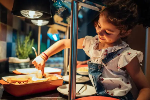 Children's buffet Girl in dungarees and white shirt