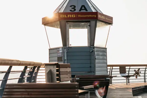 A small structure on a jetty with the sky in the background.