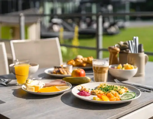 Breakfast A table with plates full of food and drinks.