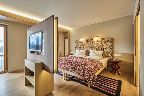 Ein Zimmer mit einem Bett und einem Fernseher.