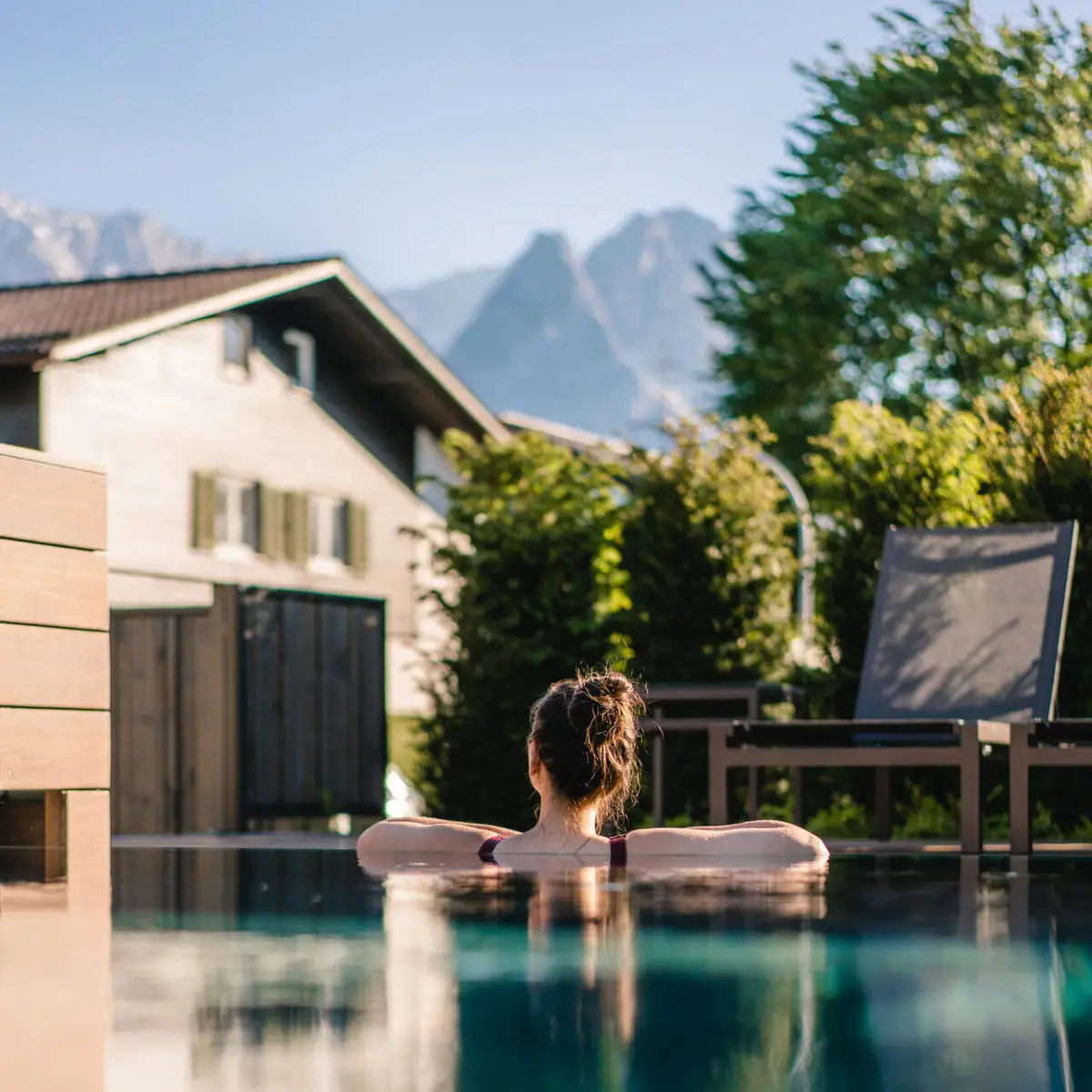 Outdoor pool  A woman swims in an outdoor pool.