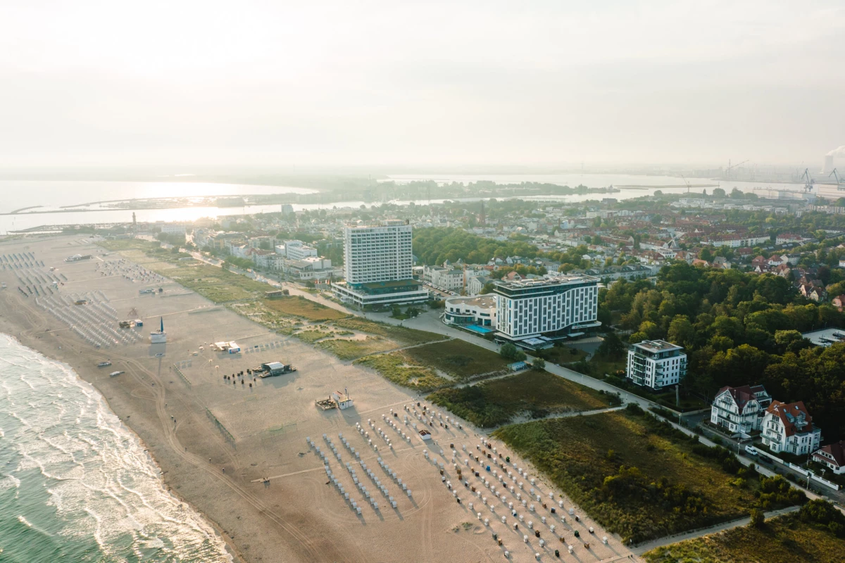 aja Warnemünde Bird's eye view of the beach with buildings and trees.