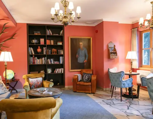Living room with a painting of a man on the wall.