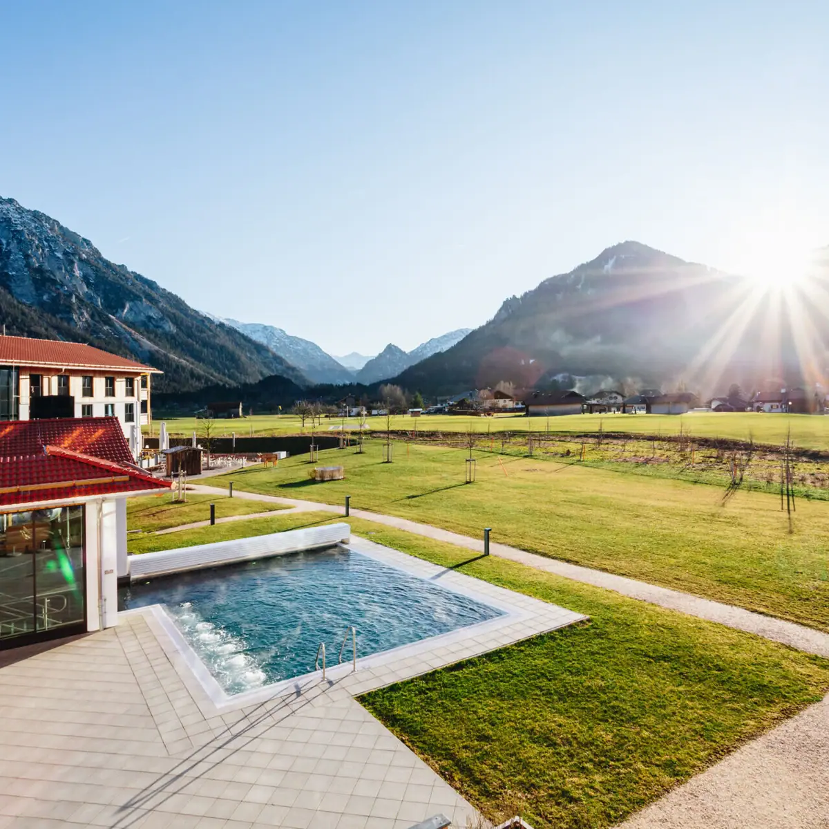 The view from the aja Ruhpolding in Chiemgau in the sunshine with a view of the mountains.