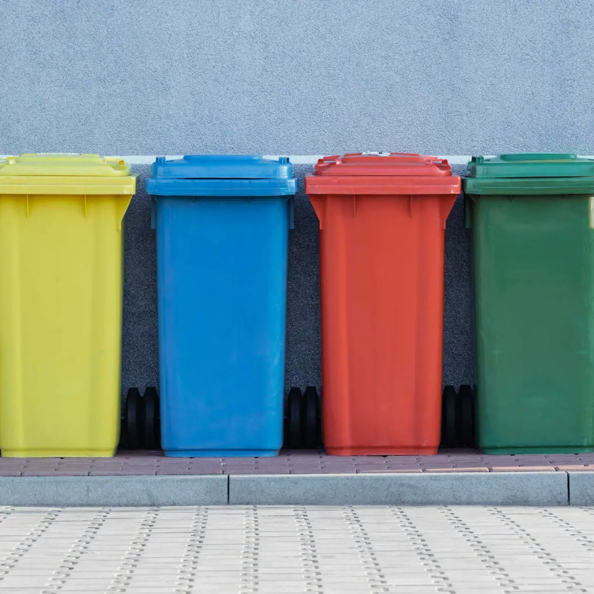 A row of colourful dustbins.