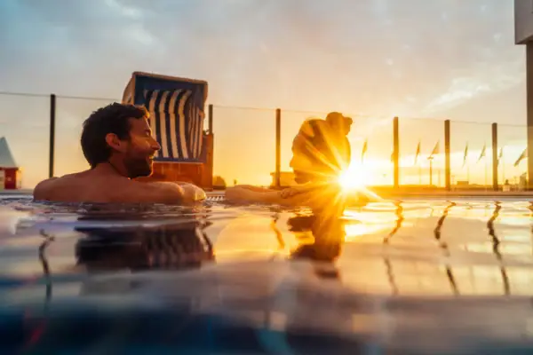 Outdoor pool A man and a woman in the pool.