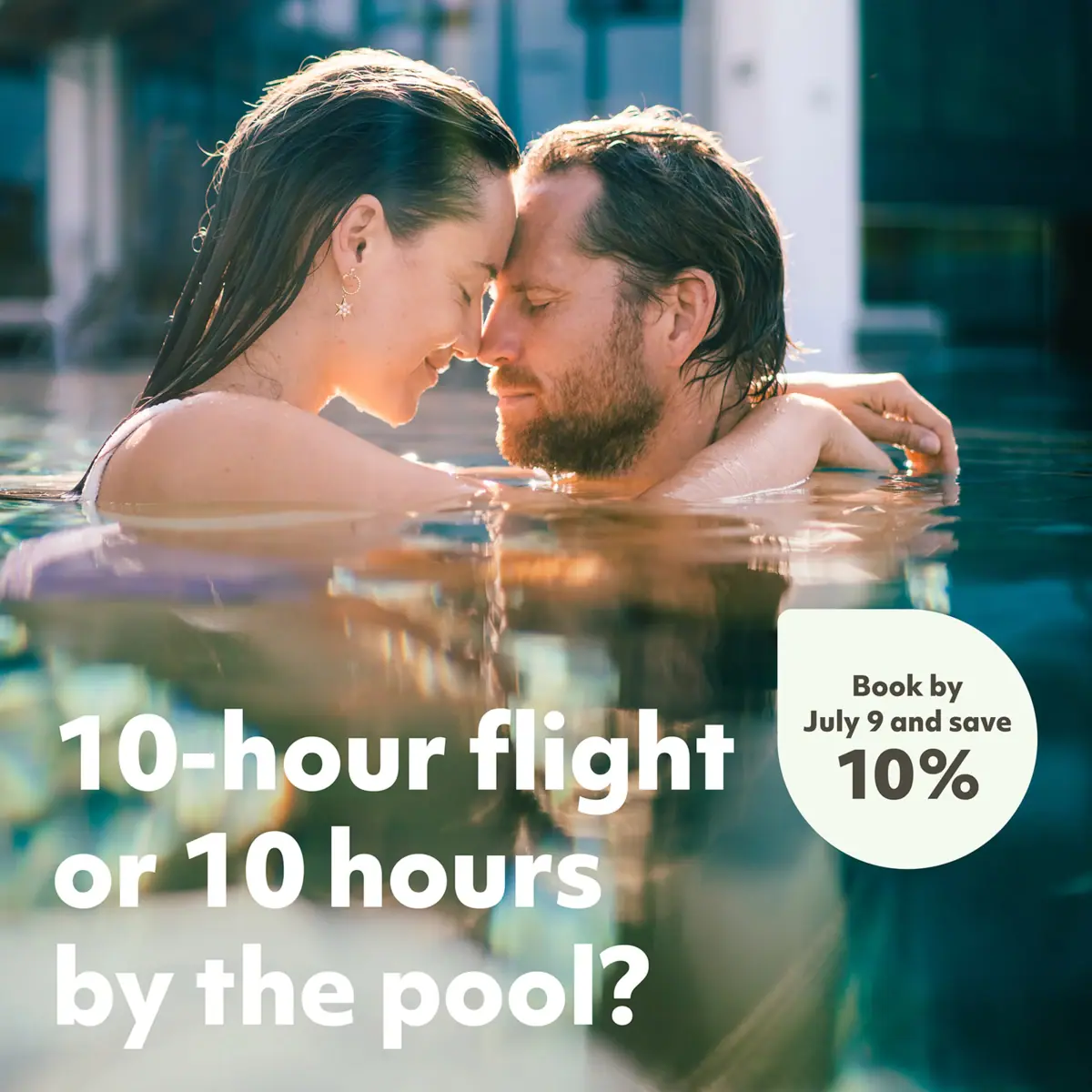 A man and woman sharing a kiss in the water.