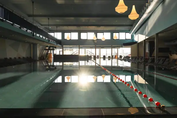 Swimming pool with a set of chairs and an indoor ladder.
