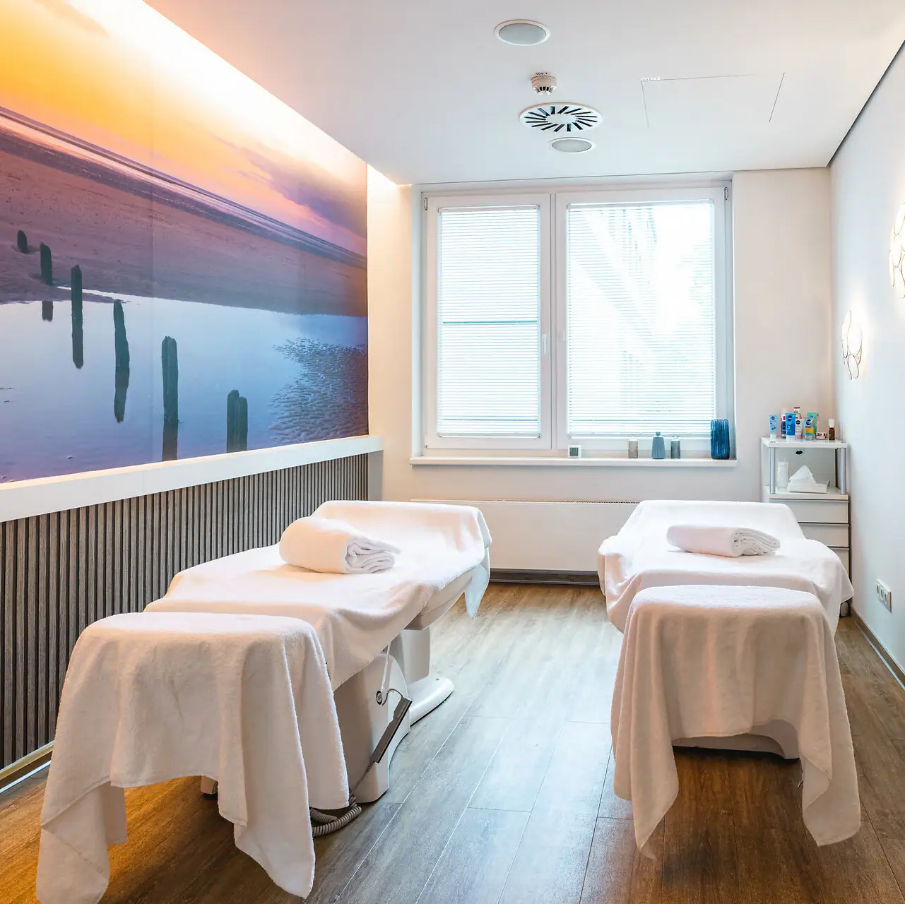 Application room A room with beds and a painting on the wall.