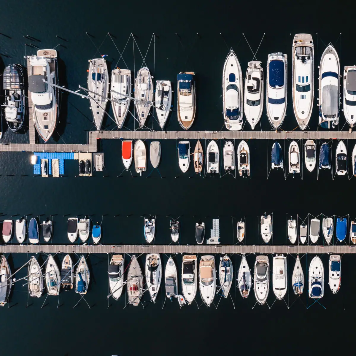 A group of boats at a jetty.