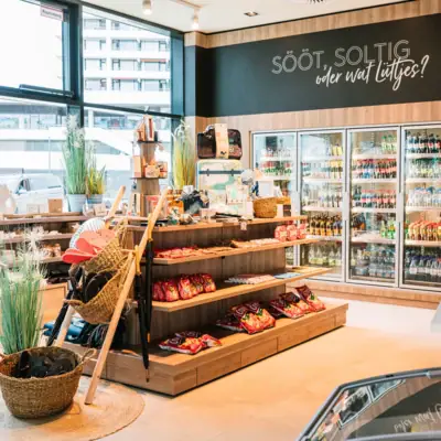 A shop with shelves full of food and drinks.