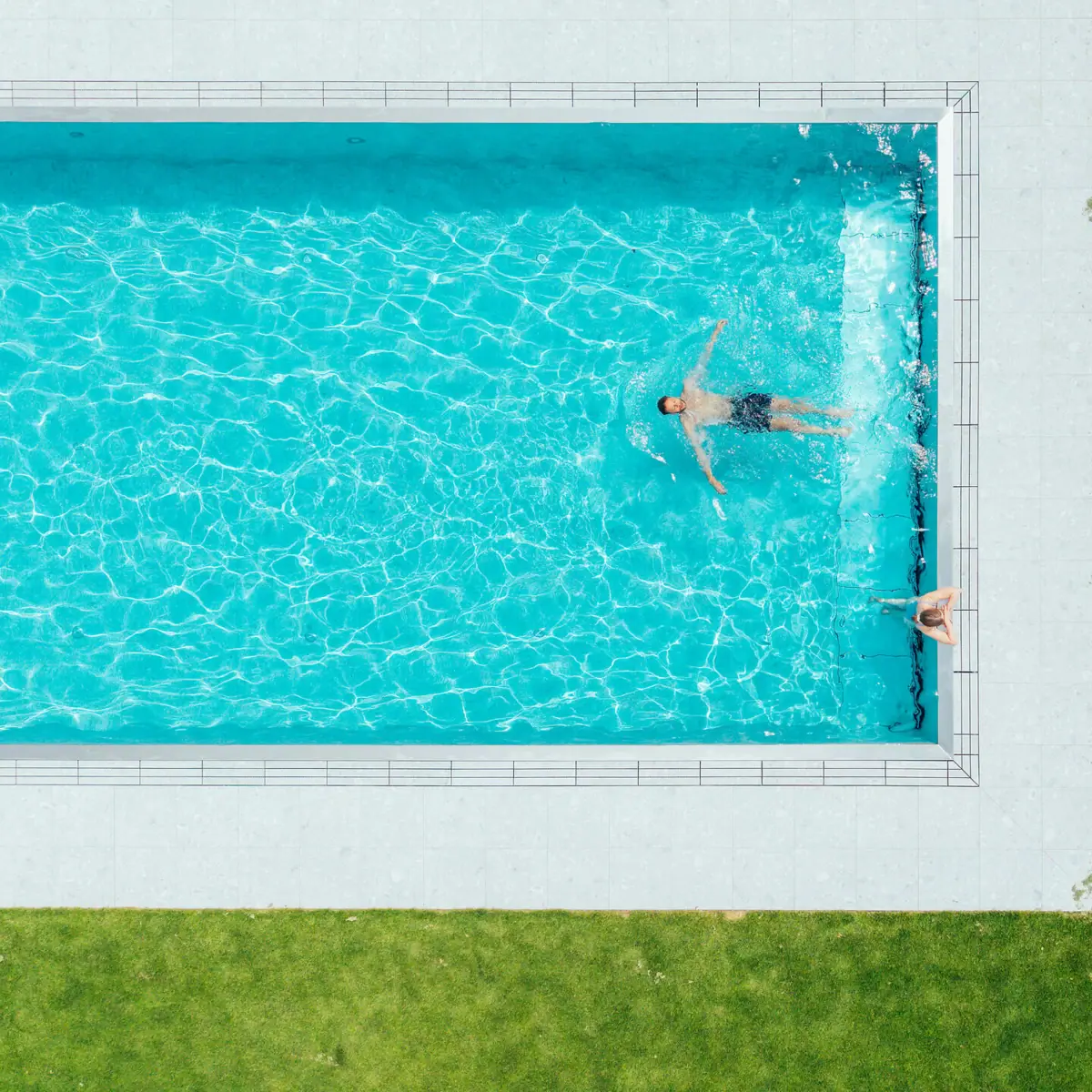 A group of people are swimming in a pool.
