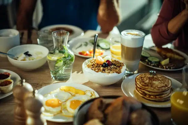 A table with plates full of food and drinks.