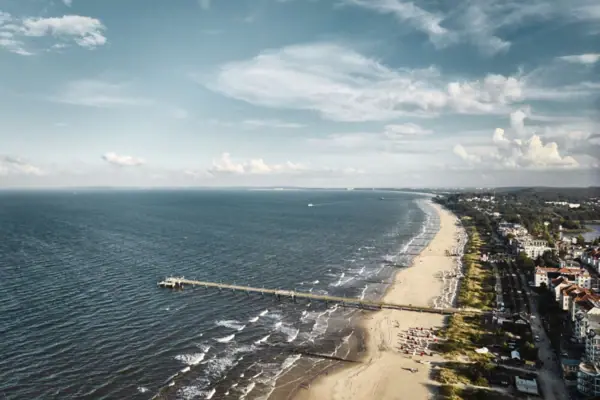 Long pier on the beach with a view of the sea and the sky.