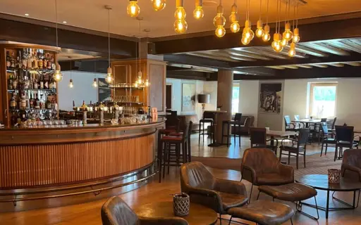 Interior of a bar and chairs and armchairs.