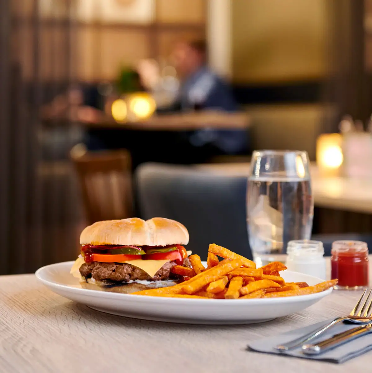 aja Bar in Warnemünde A plate of burgers and fries on a table.