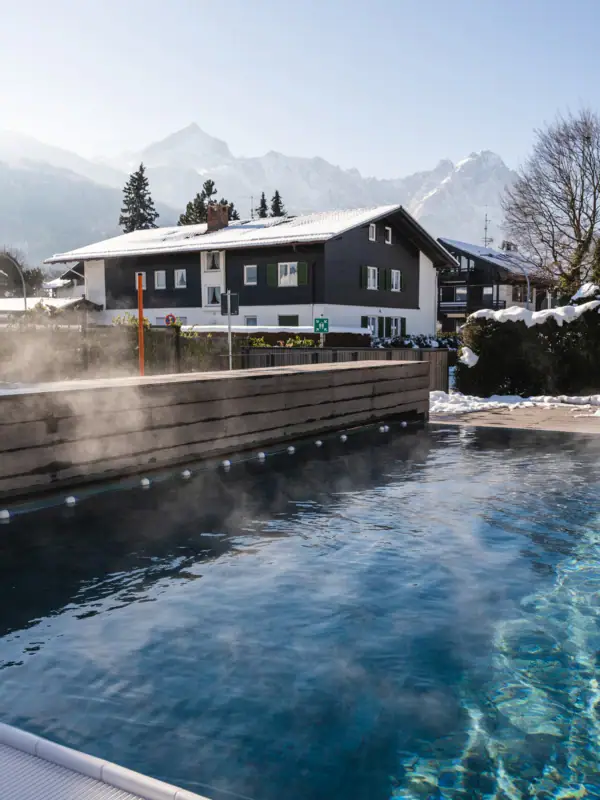 Outdoor pool in the snow A steaming outdoor pool with trees in the background.