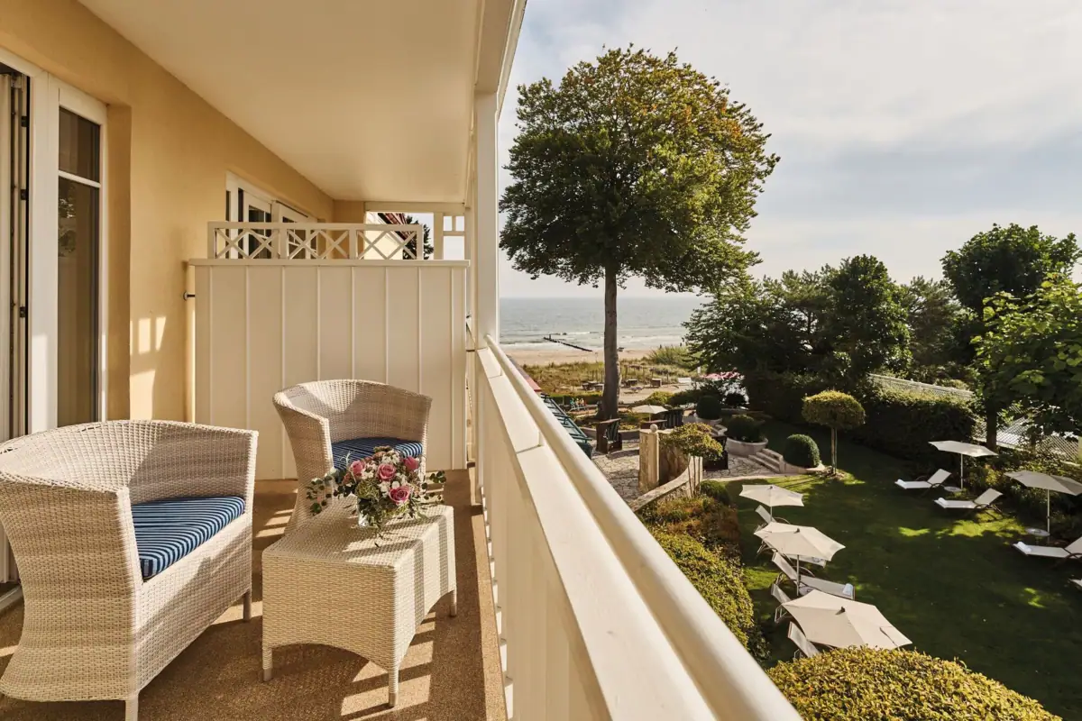 A balcony with chairs and a table.