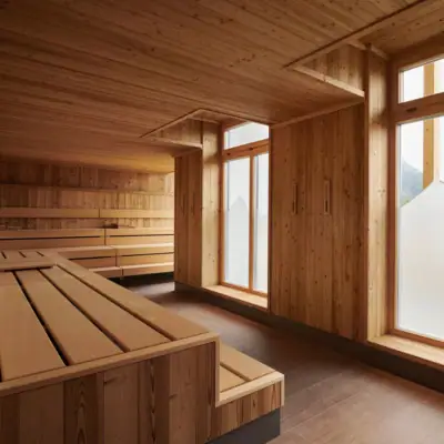 Finnish sauna at aja Ruhpolding A room with a wooden bench and windows.