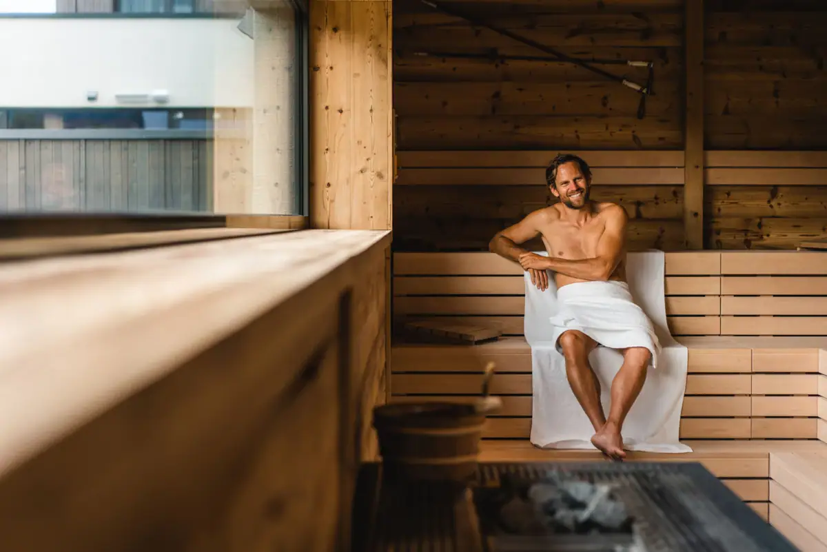Sauna A man sits in a sauna.