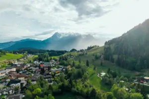 A town in a valley, surrounded by trees and mountains.