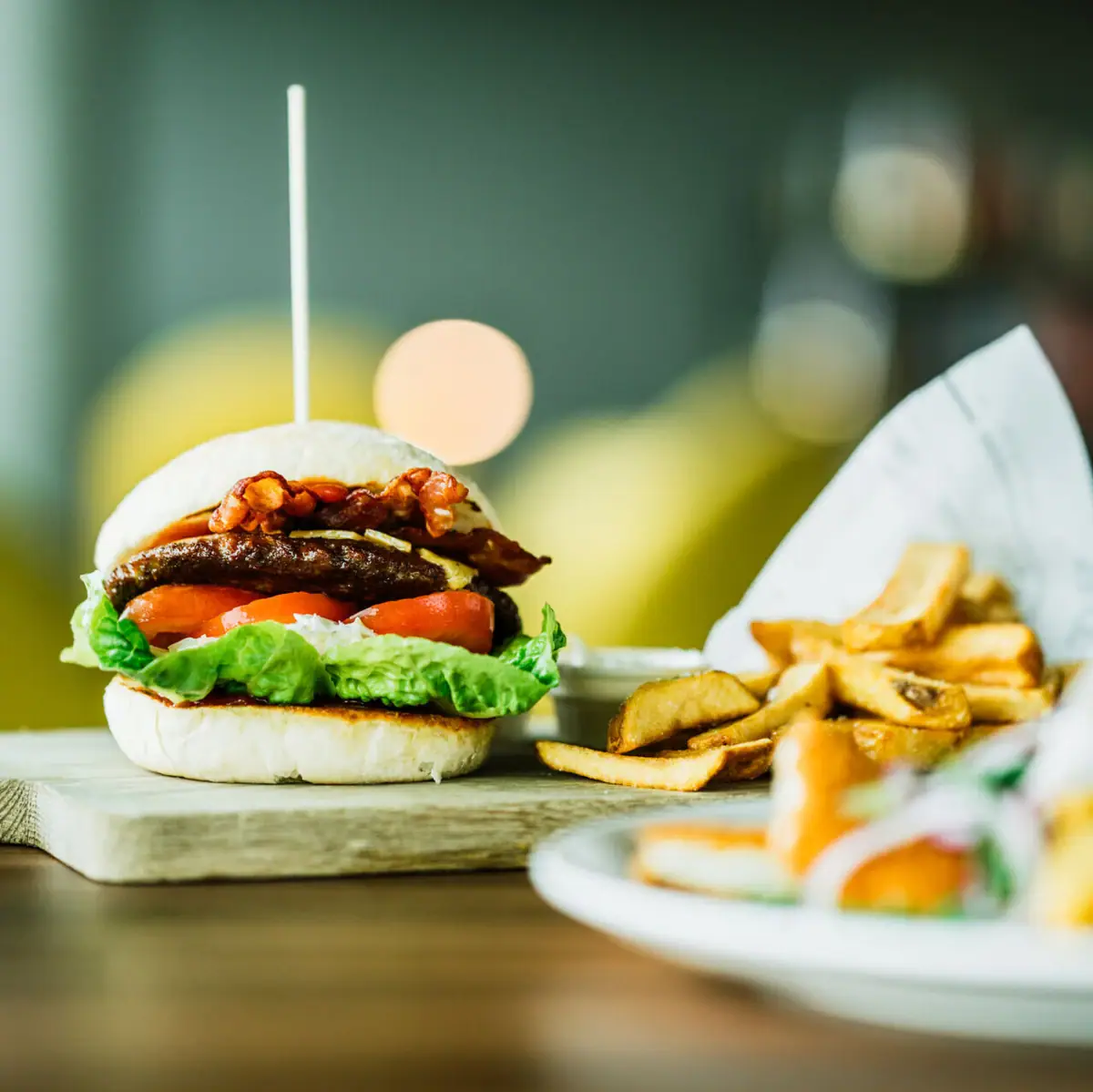 Burgers and fries on a wooden board