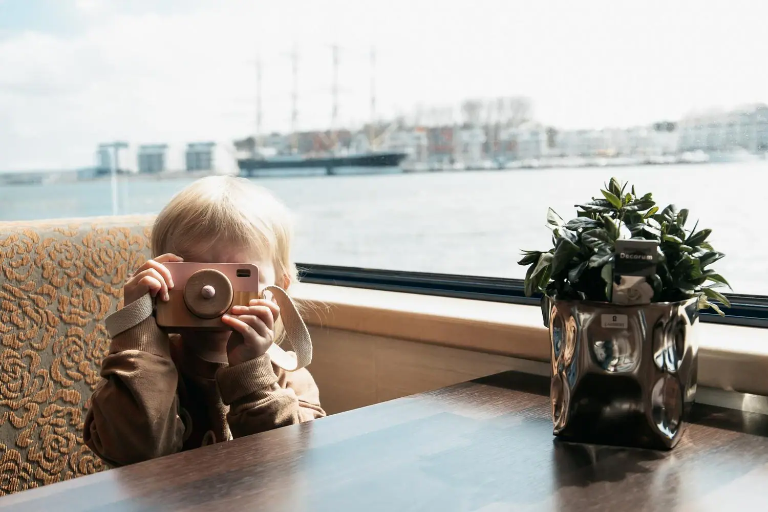 A child holds a camera.
