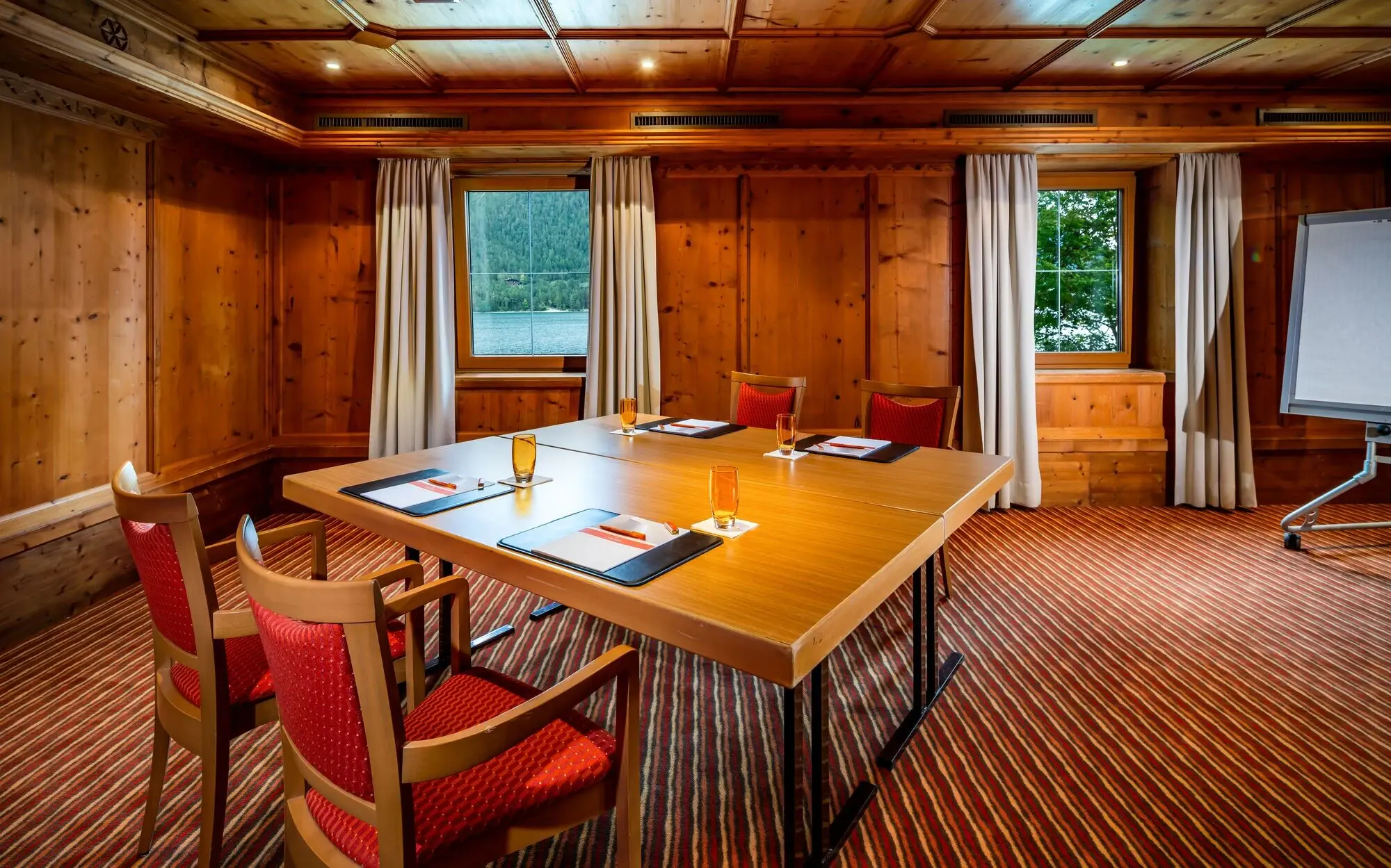 Meeting room with a table block and four chairs.