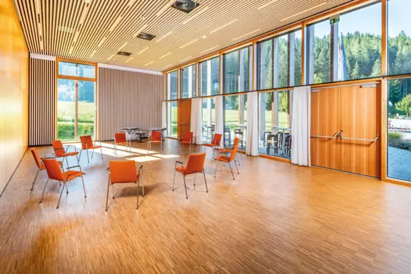 Meeting room with large floor-to-ceiling windows and a circle of chairs.