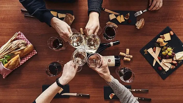 A group of people holding wine glasses.