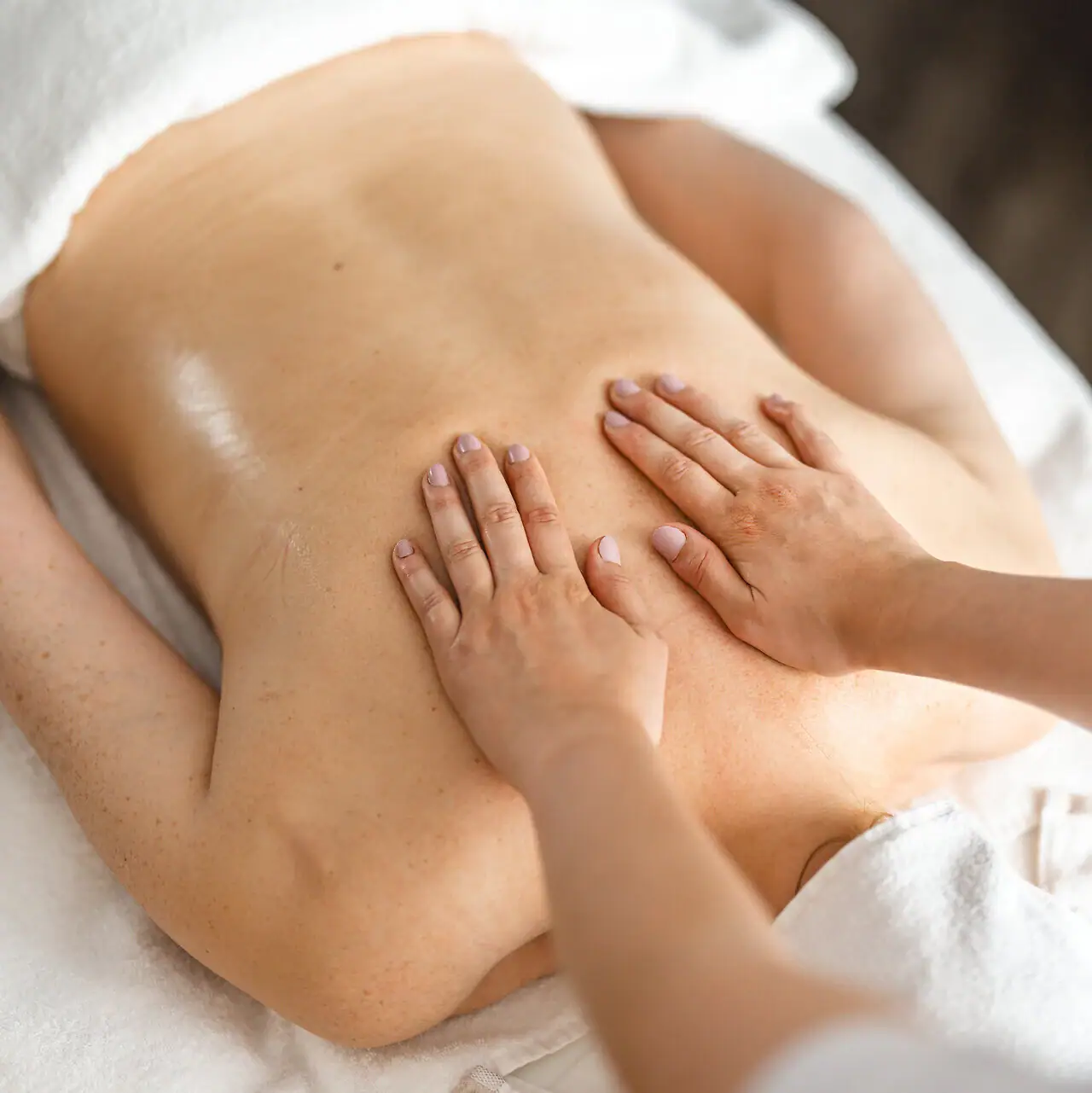 Massage One person receives a back massage.