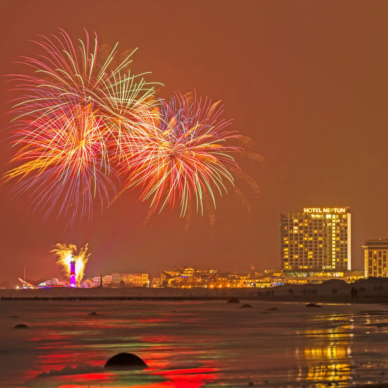 Fireworks over a beach at night