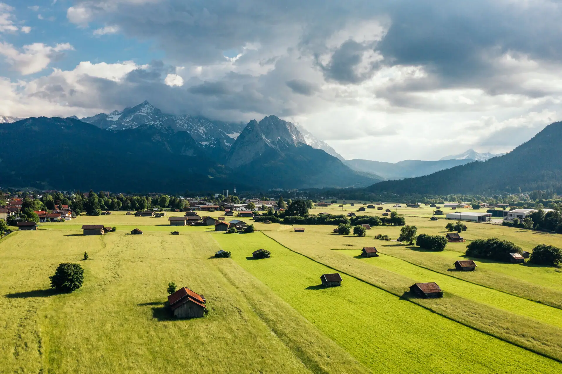 Valley Green field with buildings and mountains in the background.