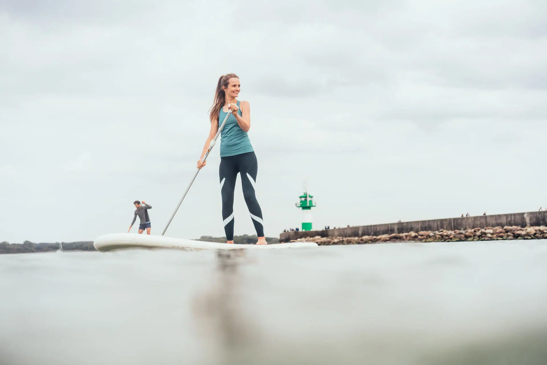 SUP on the Baltic Sea A woman and a man on a surfboard.