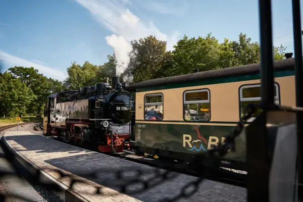 A train on the tracks in the open air.