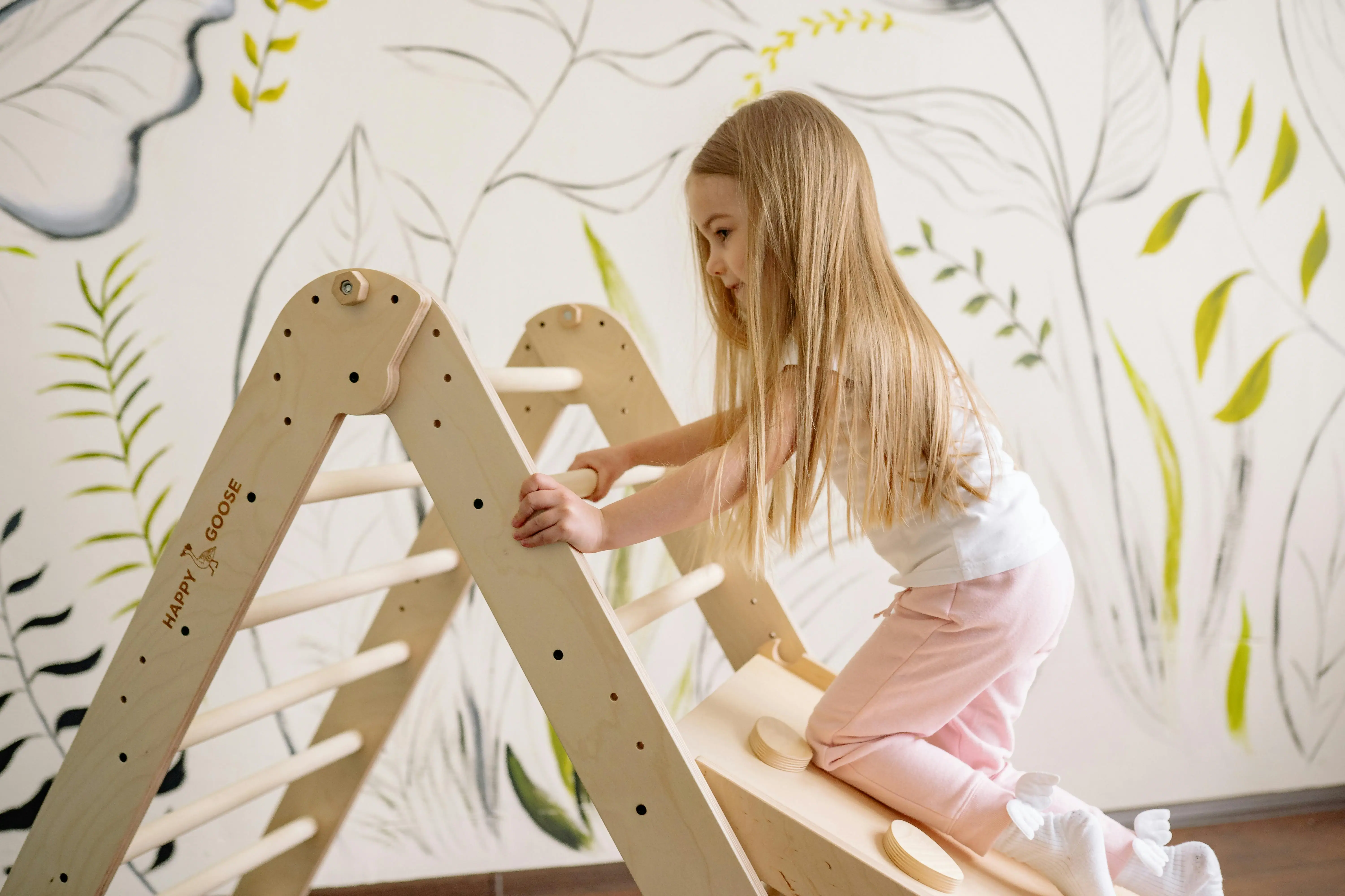 Girl playing with a wooden toy.