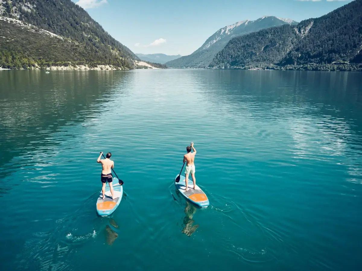 SUP on the Achensee Two men on paddleboards on a lake.