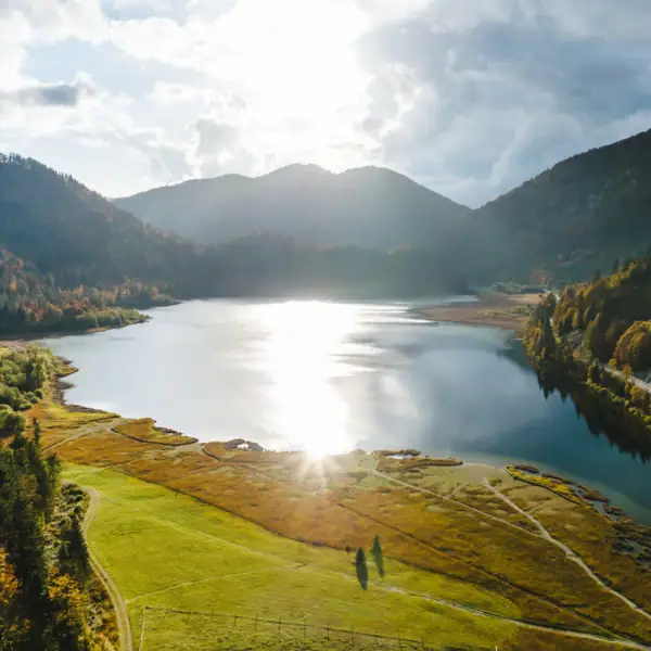 Chiemgau A lake surrounded by mountains.